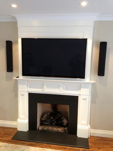 Fireplace with TV and cylindrical speakers
