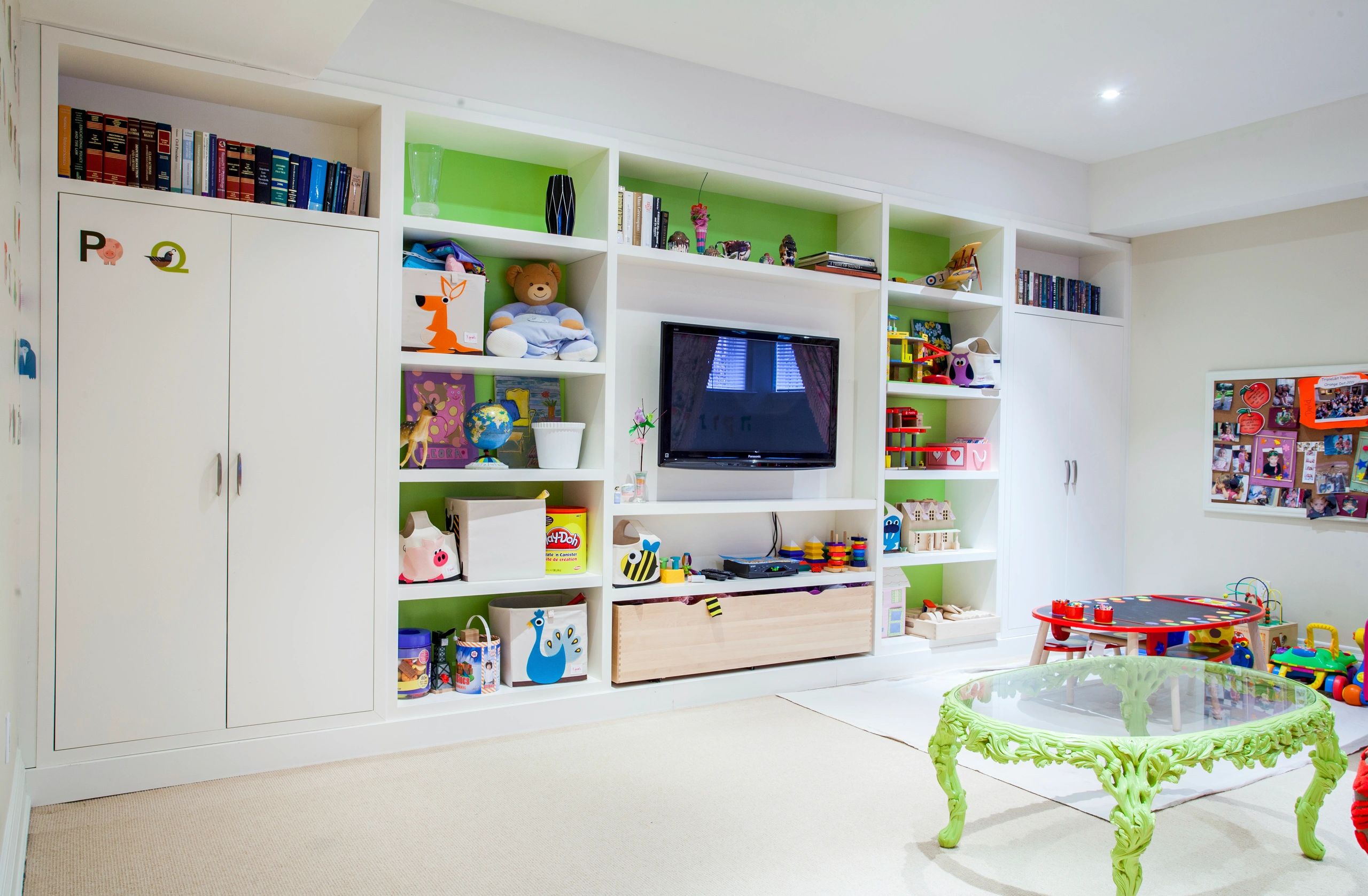 Children's playroom with built-in shelving colourful