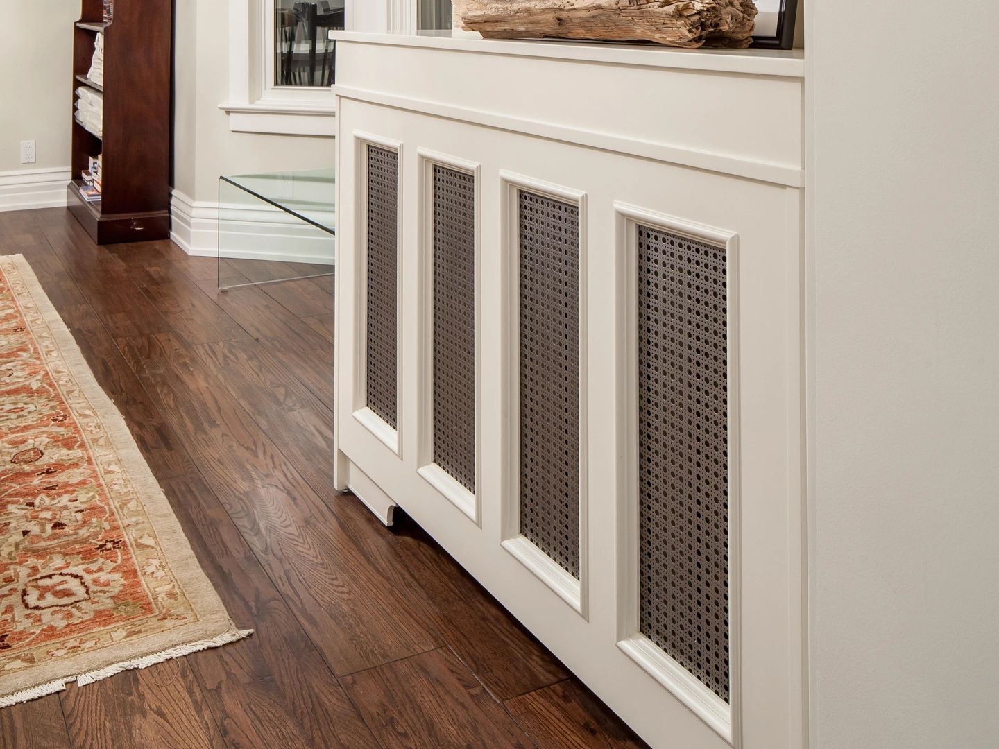 Decorative white radiator cover with brown perforated panels
